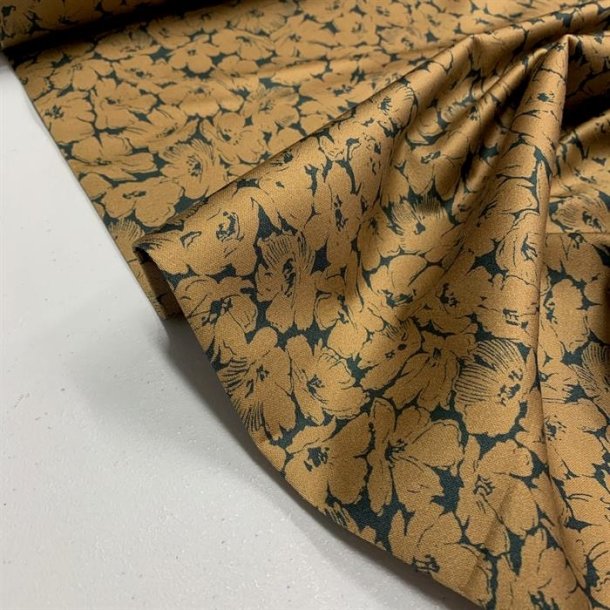 Digital printet bomuldslrred i sort med blomster i gylden okker - pr. 0,25 meter